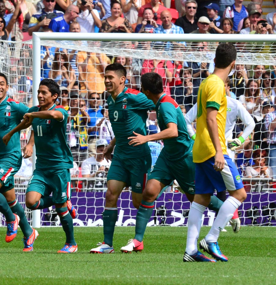 Oribe Peralta celebrates with team-mates after scoring the opening goal