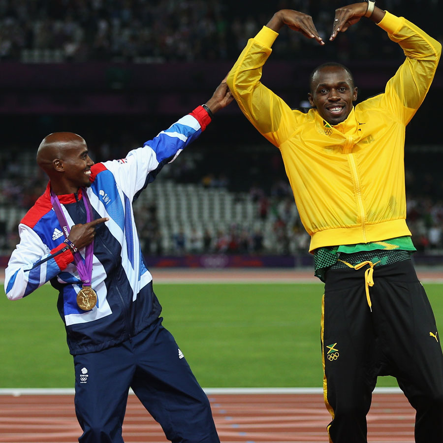 Mo Farah and Usain Bolt celebrate on the podium