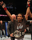 Benson Henderson raises his arms after victory