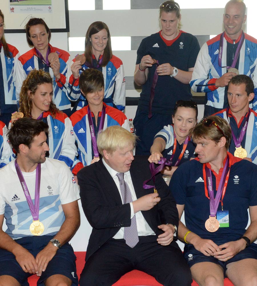 Victoria Pendleton hands Boris Johnson one of her Olympic medals 