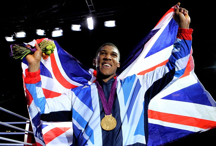 Anthony Joshua shows his delight after receiving his gold medal