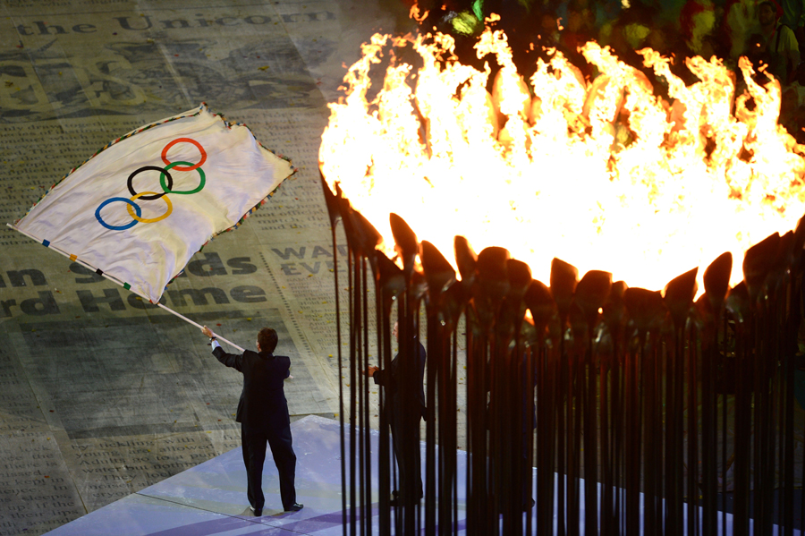 The Olympic flag is waved at the Closing Ceremony