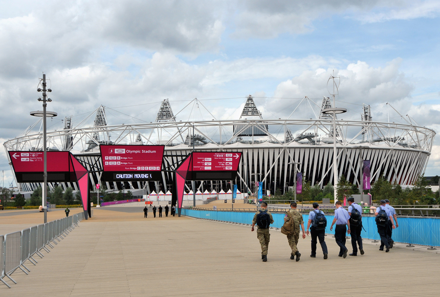Staff walk into the Olympic Park