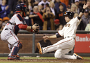 Buster Posey slides in to score