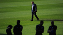 Roy Hodgson strolls across the pitch