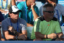 Rory McIlroy watches on with Piotr Wozniacki
