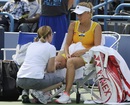 Caroline Wozniacki receives treatment on her leg