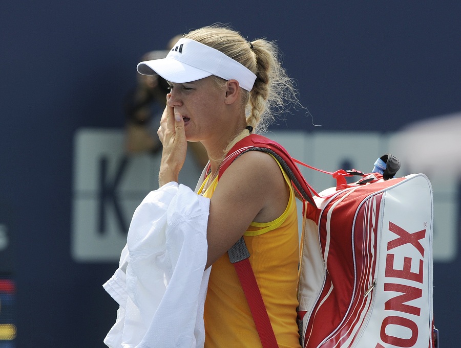 Caroline Wozniacki leaves the court after retiring from her match