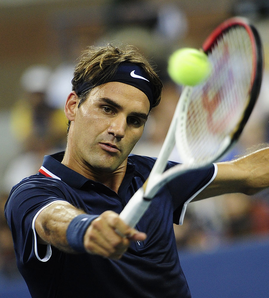 Roger Federer eyes a backhand volley