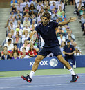 Roger Federer plays a backhand volley