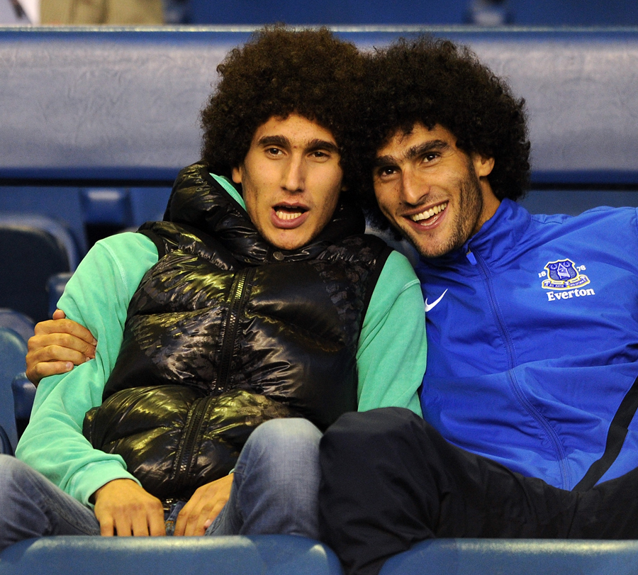 Marouane Fellaini and his brother watch the game