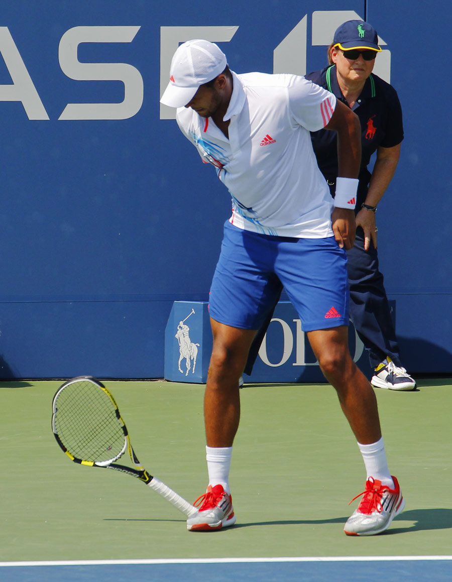 Jo-Wilfried Tsonga takes his frustration out on his racket