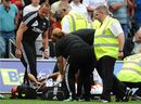 Neil Taylor receives oxygen after being tackled by Craig Gardner