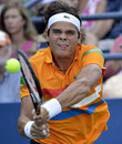 Milos Raonic stretches for a return