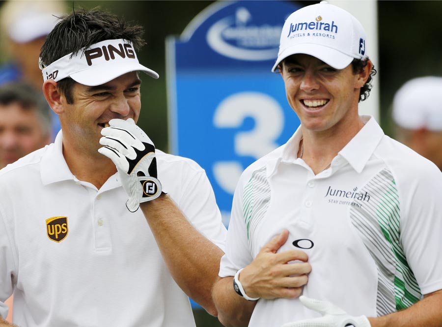 Louis Oosthuizen and Rory McIlroy laugh while waiting to tee off 