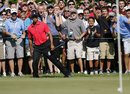 Tiger Woods urges the ball into the hole