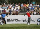 Rory McIlroy tees off on the 10th hole as Tiger Woods watches