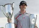 Rory McIlroy holds the Western Golf Association's JK Wadley trophy and the BMW trophy 
