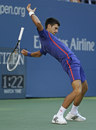 Novak Djokovic is blown back by the wind