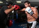 Michael Bisping hits pads during a workout session