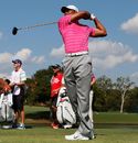 Tiger Woods watches his tee shot on the seventh hole