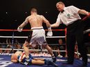 Ricky Burns is pulled away by the referee after knocking down Kevin Mitchell 