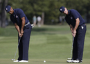 Tiger Woods and Steve Stricker practice their putting