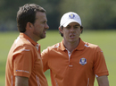 Graeme McDowell and Rory McIlroy stand greenside
