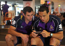 Cameron Smith and Will Chambers wait for their bags