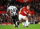 Cheick Tiote and Wayne Rooney battle for the ball

