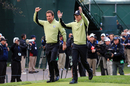 Graeme McDowell and Rory McIlroy walk off the first tee