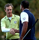 Nicolas Colsaerts and Tiger Woods shake hands