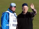 Bill Murray talks with his caddie on the second hole