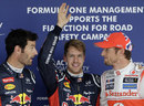 Sebastian Vettel celebrates taking pole ahead of Mark Webber and Jenson Button