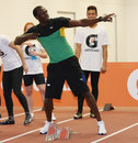 Usain Bolt performs his signature move at a training session in New Zealand