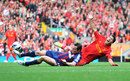 Luis Suarez is challenged by Dean Whitehead