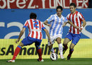 Francisco 'Isco' Alarcon takes on two Atletico Madrid players