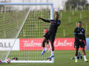 Ashley Cole jumps for a header during training