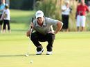 Rory McIlroy lines up a putt against Charl Schwartzel