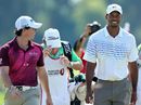 Rory McIlroy and Tiger Woods walk off the 18th green together 