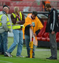 Groundsmen inspect the pitch