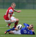 Jack Wilshere of Arsenal is challenged by Tony Hibbert