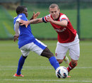 Jack Wilshere of Arsenal rides a tackle from Francisco Junior