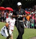 Tiger Woods walks to the first hole