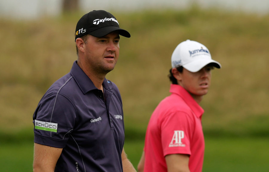 Rory McIlroy and Peter Hanson watch the action