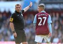 Joe Bennett walks off the pitch dejected after being shown a red card by Phil Dowd