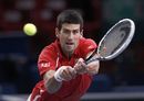 Novak Djokovic lunges into a backhand