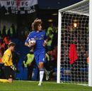 David Luiz collects the ball from the net after scoring his penalty