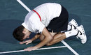 Jerzy Janowicz collapses to the floor after his victory