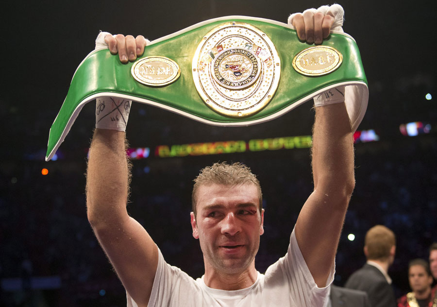 Lucian Bute lifts the North American Boxing Federation light heavyweight belt after defeating Denis Grachev